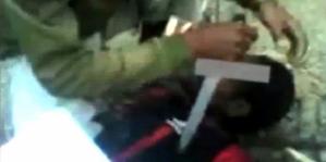 Salah satu cuplikan adegan penyiksaan terhadap seorang warga Papua yang diduga terlibat dalam Organisasi Papua Merdeka (OPM).